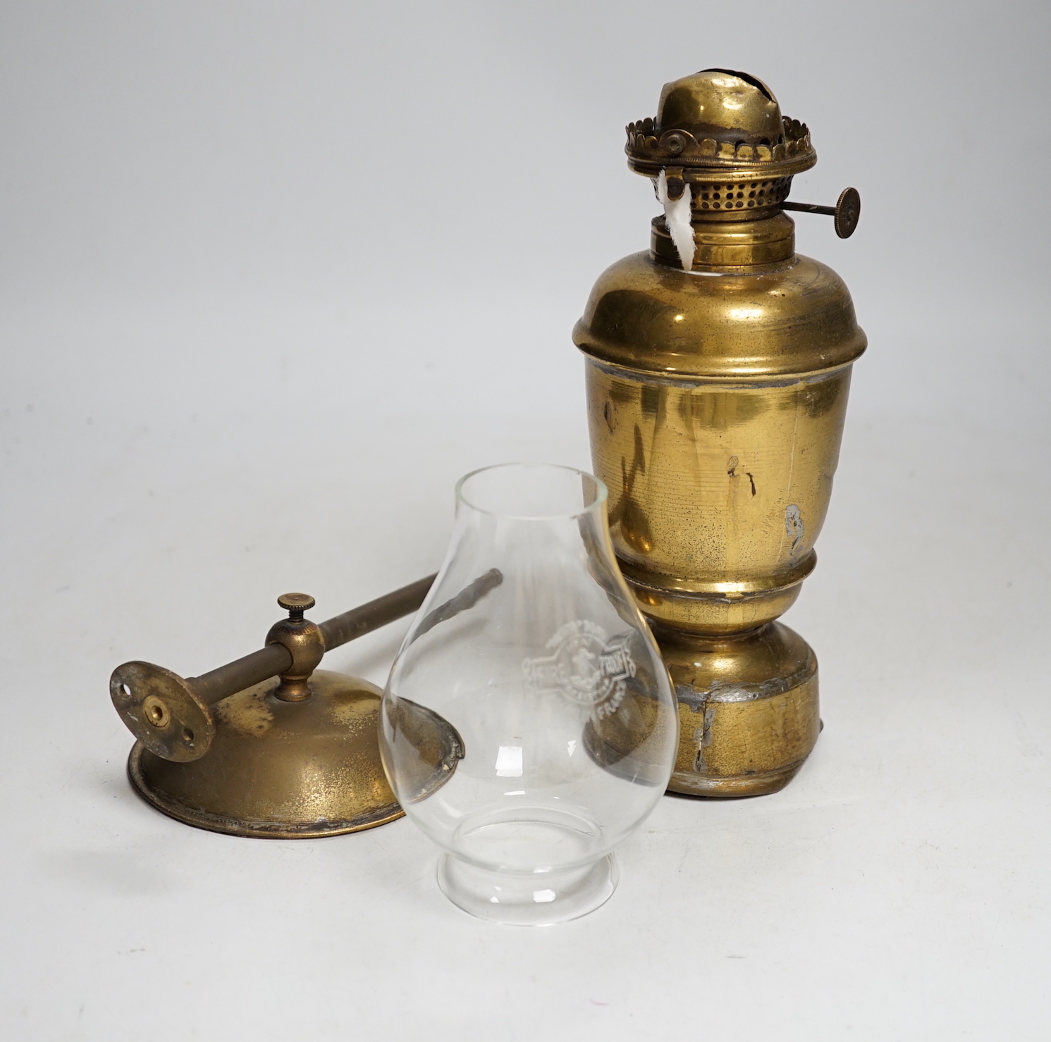 A pair of brass ship design lanterns with glass shades